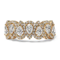 a yellow gold ring with pear shaped diamonds on the sides and two rows of smaller pears in the middle