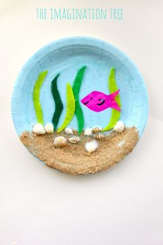 a paper plate with an image of a pink fish and seaweed on the bottom