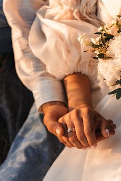 the bride and groom hold hands with their wedding rings