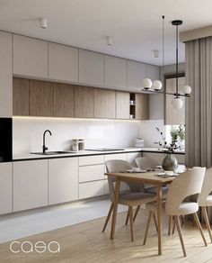 a modern kitchen and dining room are shown in this image, with the table set for four