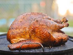 a whole chicken sitting on top of a grill