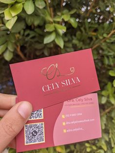 someone holding up a business card in front of some bushes and trees with the word cen siva on it