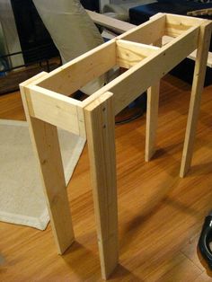 a table made out of wooden planks sitting on top of a hard wood floor