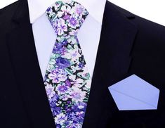 Purple, Green, and White Floret Silk Tie Picture this: you're dressing up for a special occasion, and you want to make a bold statement with your outfit. You reach for a luxurious silk necktie that catches your eye. Its luscious fabric feels silky smooth in your hands, and the intricate floral pattern in shades of purple, green, and white is mesmerizing. The playful yet sophisticated design makes you feel confident and daring. As you tie the knot of the necktie, you realize that the soft purple Elegant Floral Print Accessories For Black Tie, Elegant Floral Print Ties For Gifts, Elegant Floral Print Ties As A Gift, Elegant Floral Print Ties As Gift, Elegant Floral Print Ties For Spring, Elegant Patterned Tie With Floral Print, Floral Print Ties For Spring Formal Events, Spring Floral Print Ties For Formal Occasions, Formal Floral Print Ties For Spring