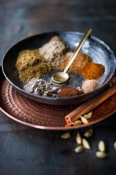 an assortment of spices in a metal bowl