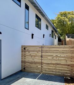 a wooden fence next to a white house