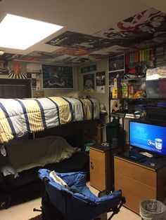 a dorm room with bunk beds and desks