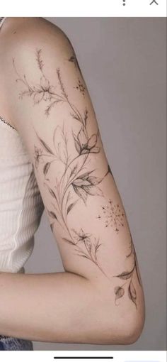 a woman's arm with flowers on it, and an arrow in the middle