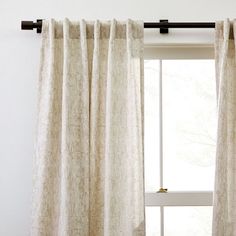 an open window with white curtains in front of it