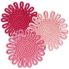 three pink rugs with spiral designs on them