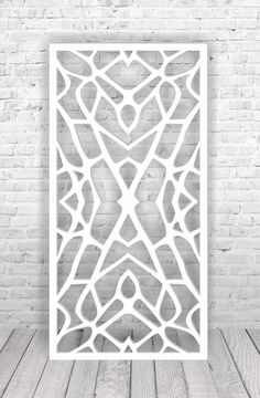 a white poster on a brick wall with an abstract design in the middle and bottom