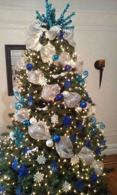 a decorated christmas tree with blue and white ornaments