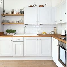 the kitchen is clean and ready for us to use it's white cabinetry