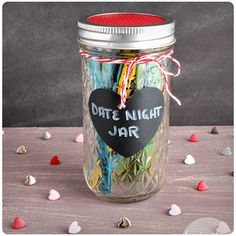 a jar filled with candy canes and a chalkboard that says date night jar