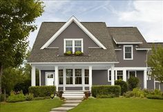 a blue house with white trim on the front door and steps leading up to it