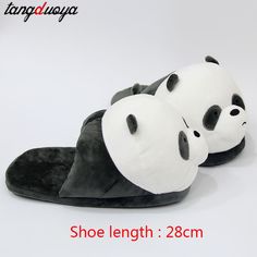 two panda slippers with black and white faces are laying on top of each other