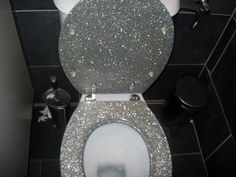 the toilet is covered in gold glitters