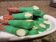 there are carrots wrapped in green and white paper on a plate with other food items