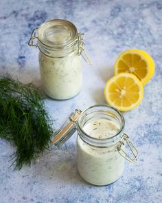 two mason jars filled with lemon and dill