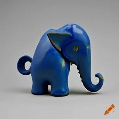 a blue elephant figurine sitting on top of a table