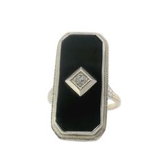 This stunning Black Onyx and Diamond Art Deco Ring features intricate filigree detailing and a bold black onyx centerpiece with a center diamond. A unique and timeless piece, perfect for adding elegant sophistication to any outfit. Jewelry Style : Ring Metal Type : 14K Gold  Diamond : 1 round diamond  Ring Size : 6.75 : Can be sized by your jeweler Black Onyx : Approximately 23mm x 10mm estate piece, sold as is, all weights are estimates Diamond Art Deco Ring, Art Deco Diamond Rings, Outfit Jewelry, Round Diamond Ring, Zodiac Pendant, Jewelry Style, Deco Ring, Pearl Diamond, Vintage Engagement