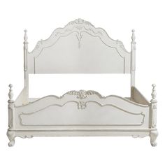 a white bed with an ornate headboard and foot board on it's sides