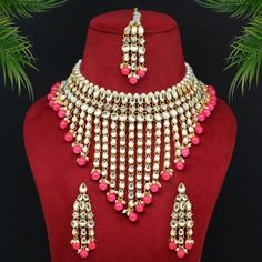 Indian Wedding Jewelry Set For your special day or that special occasion where you standout. this is the perfect necklace set! Item Specifications & Care: Dark Peach Color Kundan Necklace Set Adjustable Rope | Necklace Length: 24.00 CM x Width: 12.00 CM Earring Length: 7.00 CM x Width: 2.30 CM Maang Tikka Length: 18.00 CM x Width: 2.30 CM Metal: Alloy With Good Quality Gold Plated Color: Dark Peach | Stone: Kundan & Imitation Pearl Gross Weight: 272.00 Grams Package Content: 1 Piece Of Necklace::1 Pair Of Earring::1 Piece Of Maang Tikka Back Finding: Post with Friction Back x Earring Style: Drop Care:  Avoid exposure to heat, chemicals, perfume, alcohol, hair spray, water Avoid wearing jewelry while cooking, working out as sweat can potentially change color of jewelry Always put on your je Festive Rose Gold Jewelry For Celebration, Festive Celebration Rose Gold Jewelry, Traditional Jewelry For Valentine's Day Celebration, White Jewelry For Valentine's Day Celebration, Valentine's Day Wedding Jewelry With Matching Earrings, Traditional Adjustable Jewelry For Valentine's Day, Pink Necklaces With Matching Earrings For Party, Pink Bridal Sets For Festive Occasion Gift, Pink Bridal Sets For Festive Gift