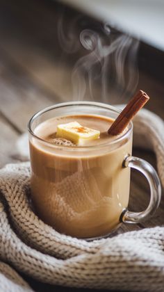 hot chocolate drink with cinnamon stick in glass mug