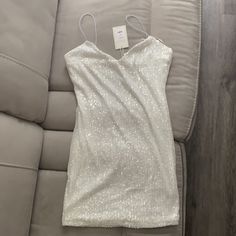 White Sequin Dress Bought For Bach Party Never Worn Nwt Size Large. Im 5'8 And Dress Wasnt Too Short For Me. Super Cute And Fun White Mini Dress For Date Night Holiday, White Sequin Dress For Date Night In Party Season, White Sequin Dress For Date Night During Party Season, White Sequin Dress For Date Night And Party Season, Short White Sparkly Dress, White Sequin Mini Dress For Date Night, White Mini Sequin Dress For Date Night, White Sleeveless Mini Dress For Holidays, Holiday White Sleeveless Mini Dress