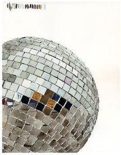 a large mirror ball sitting on top of a white floor