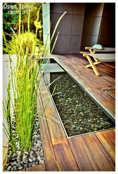 a wooden bench sitting on top of a lush green field