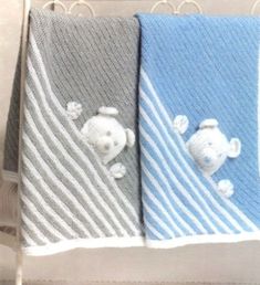 two towels with teddy bears on them in blue and grey colors, one has a white bear