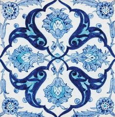 a blue and white tile with an ornate design