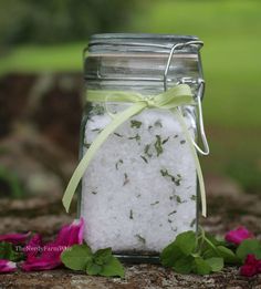 a jar filled with white sand and flowers