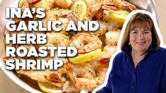 a woman standing in front of a pan filled with shrimp and lemons, next to the words ina's garlic and herb roasted shrimp