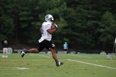 a football player running with the ball in his hand