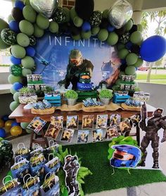 a table with balloons and decorations for an infinitite party on the lawn