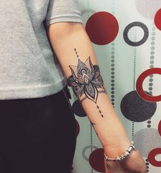 a woman's arm with a tattoo on it and a flower in the middle