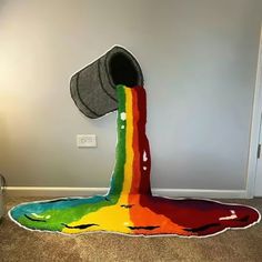 a rainbow painted toilet in the corner of a room