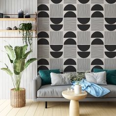 a modern living room with black and white wallpaper on the walls, green plants in vases