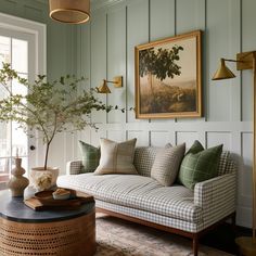 a living room filled with furniture and a potted plant on top of a table