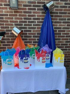 there are many bags on the table with paper umbrellas attached to them and one bag is empty