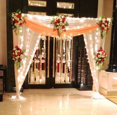 an entrance decorated with flowers and lights