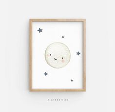 a white framed wall hanging with stars and a smiling moon in the sky above it