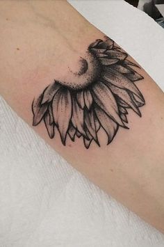 a black and white photo of a sunflower tattoo