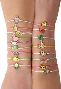 two girls wearing different bracelets with cartoon characters on them