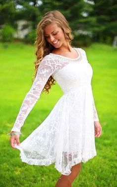 a beautiful young woman posing in a white dress