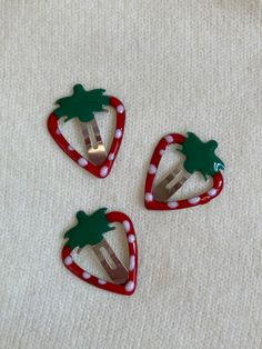 three pieces of fruit shaped like forks with palm trees on them sitting on a white surface