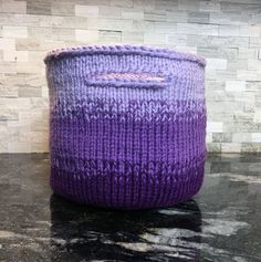 a purple knitted basket sitting on top of a counter