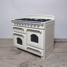 an old fashioned white stove with two ovens on it's front and back sides